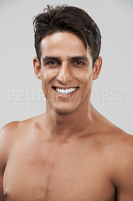Buy stock photo Man, portrait and smile for skincare in studio, cosmetology and glow by gray background or shine. Male person, face and happy for beauty and dermatology, care and satisfaction in facial treatment