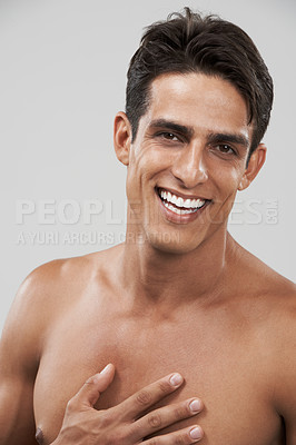 Buy stock photo Man, shirtless and portrait or beauty in studio, smiling and joyful by gray background. Happy male person, confident and skincare or body care, face and wellness or relaxing by backdrop and treatment