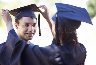 Buy stock photo Couple, graduate and woman fix man graduation cap, education and academic success with ceremony. Certification, achievement and event at university with people together for milestone and award