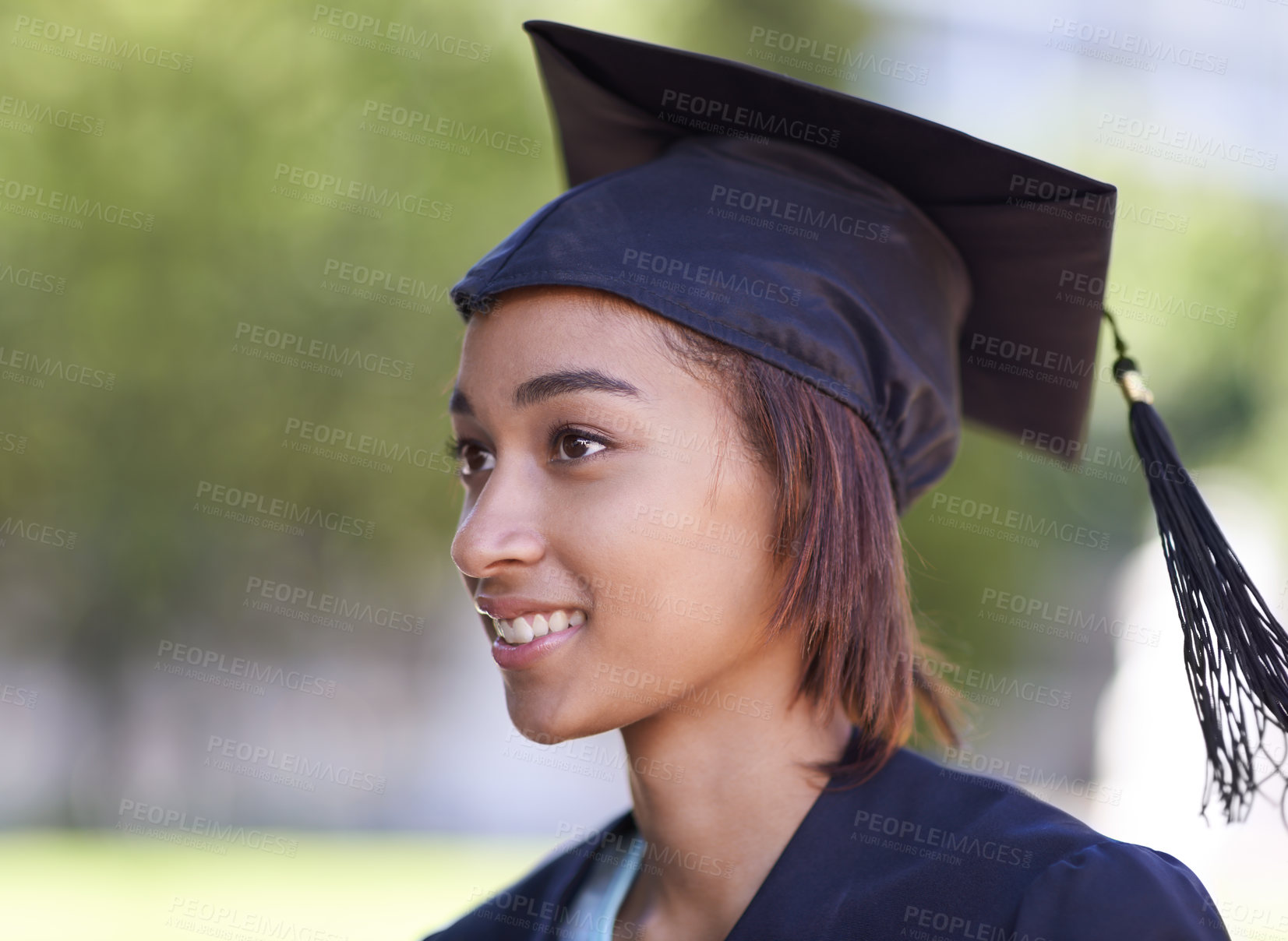 Buy stock photo Woman, graduate and college achievement with education, cap and gown for ceremony outdoor. Mockup space, smile and graduation event for academic success, higher learning and certification with pride