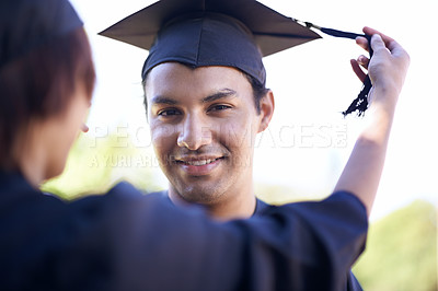 Buy stock photo A smiling graduate with his graduation hat on