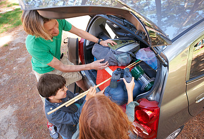 Buy stock photo Happy family, road trip and packing car above for camping, holiday or vacation together in nature outdoors. Top view of dad and kids getting ready for travel, camp adventure or getaway in the forest