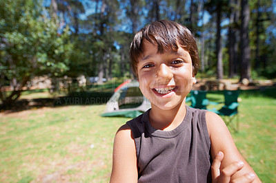 Buy stock photo Child, portrait and fun on camping adventure in outdoors, boy and relaxing on vacation or holiday. Happy male person, kid and face or confident in park, childhood and summer or freedom on lawn