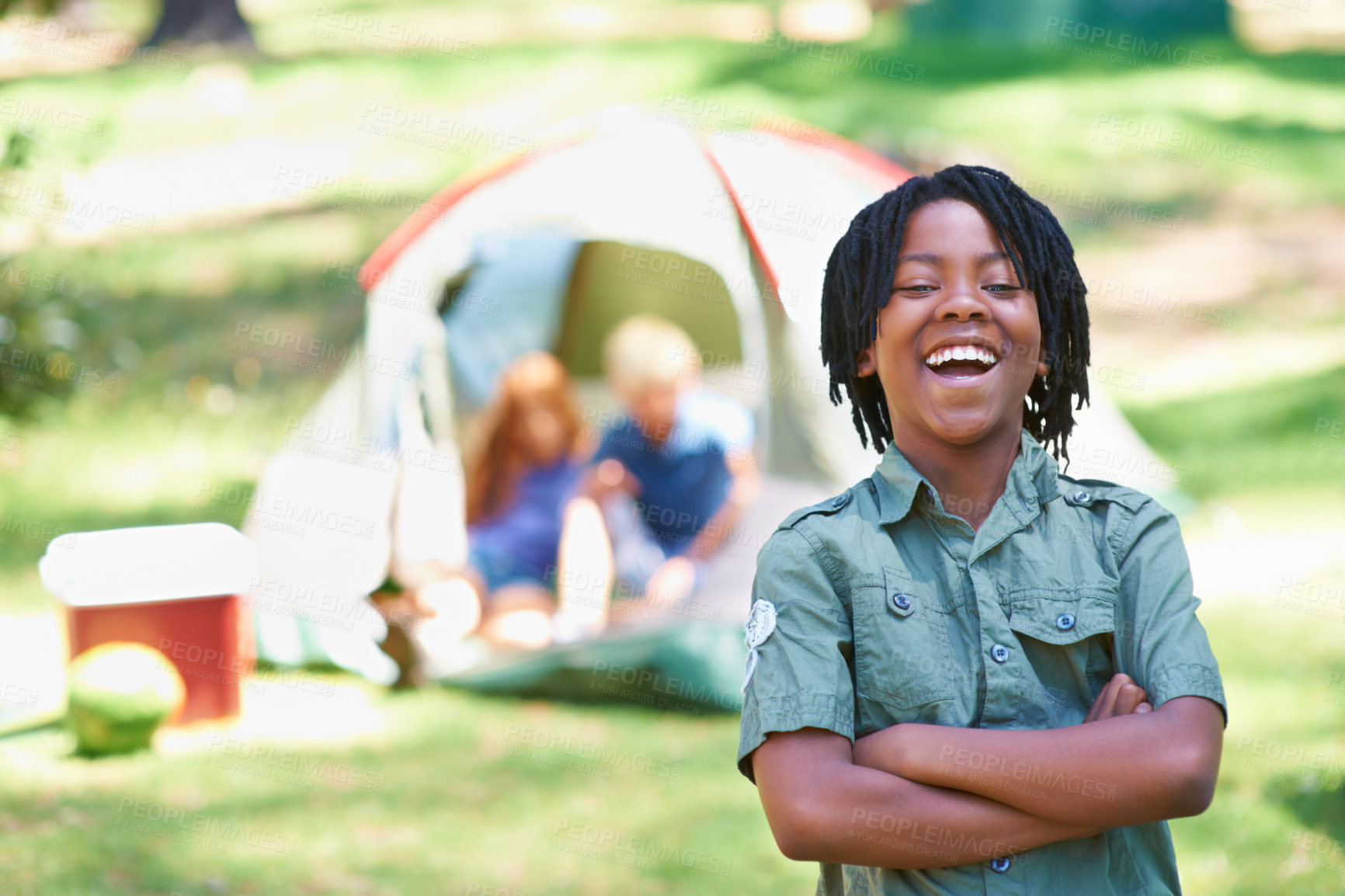 Buy stock photo Boy, kid laughing with arms crossed at summer camp and nature with fun outdoor for youth. African child at campsite in park, adventure and vacation, childhood with recreation and happy in portrait