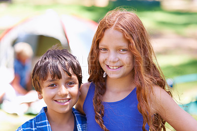 Buy stock photo Camping, children and relaxing in portrait while outside, bonding and happy for outdoor adventure. Kids, face and smiling together on holiday, friendship and vacation in nature, childhood and grass
