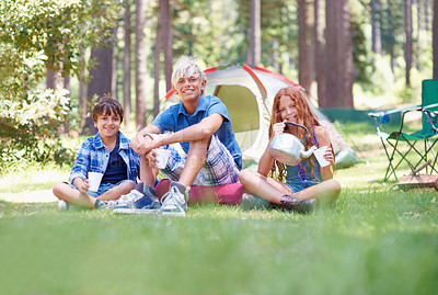 Buy stock photo Camping, children and relaxing in portrait while outside, bonding and happy for outdoor adventure. Kids, face and eating food together on holiday, friendship and nutrition in nature, smile and grass