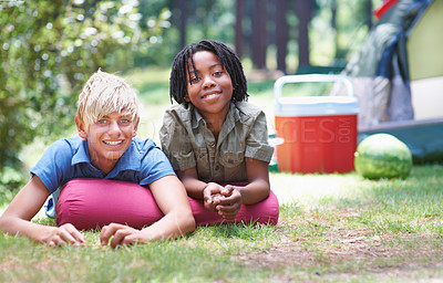 Buy stock photo Camping, children and relaxing in portrait on ground, bonding and boys in outdoor adventure. Happy kids, face and smiling together on holiday, friendship and vacation in nature, outside and grass