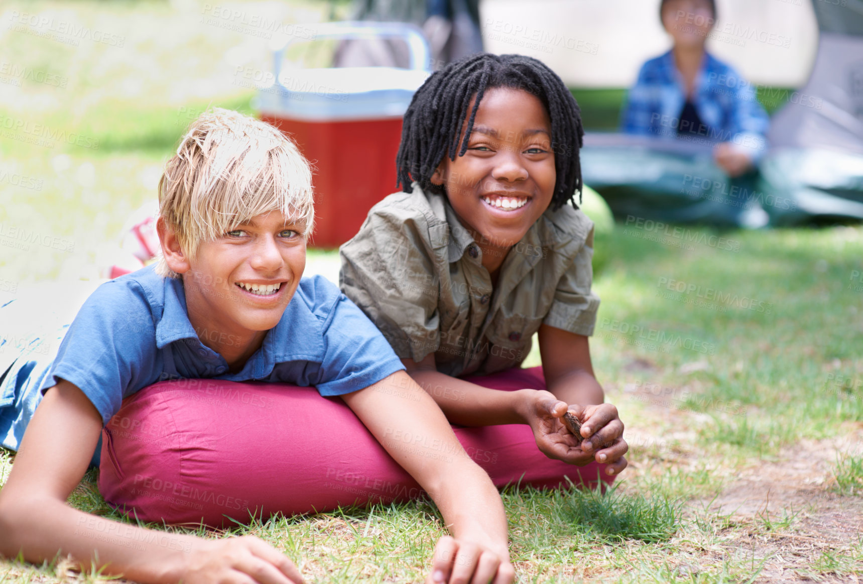 Buy stock photo Camping, children and relaxing in portrait on outdoor adventure, bonding and happy outside. Kids, face and smiling together on holiday, friendship and vacation in nature, park and grass on ground