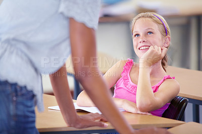 Buy stock photo Child, girl and listening, student and teacher with interest in information and learning in classroom. Attention, smart and happy kid, education and teaching with people at school for knowledge