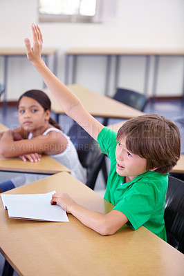 Buy stock photo Child raise his hand in school for questions, support and help with classroom education and teaching in school development. Clever boy or kid with arm up for knowledge, learning and answer or advice