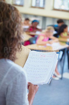 Buy stock photo Classroom, test papers and school of students or learners in exam, files or results with folder. Closeup of teacher, academic and education for grading person for assignments, scholar and class grade