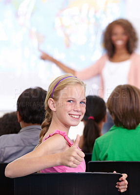 Buy stock photo Thumbs up, classroom and child portrait for happy learning, support and thank you sign for education success, school or geography. Like, yes and achievement hand or emoji of girl kid in map teaching