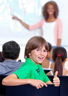 Buy stock photo Thumbs up, teaching and child portrait for happy learning, support and thank you with education success, school or geography. Like, yes and achievement hand or emoji of boy kid with map in classroom