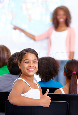 Buy stock photo Happy student, portrait and child with thumbs up in class for winning or success together at school. Young female person, kid or girl smile with like emoji, yes sign or OK for education in classroom
