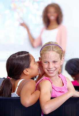 Buy stock photo Little girls, whisper and classroom in ear for secret, gossip or communication in lesson at school. Children, students or friends listening to rumor, information or class together with teacher