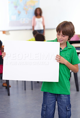 Buy stock photo Boy, child and poster in classroom for education or learning with teacher at school. Young male person, little teen or kid smile with banner for advertising, message or marketing on mockup space
