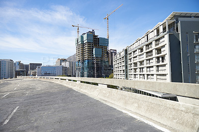 Buy stock photo City, road and CBD of Cape Town construction, industrial architecture or buildings in urban suburb. Asphalt street and concrete infrastructure with blue sky, cranes and empty bridge in South Africa