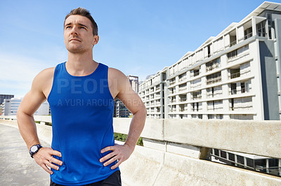 Buy stock photo Proud young man ready for a brisk run in the city roads