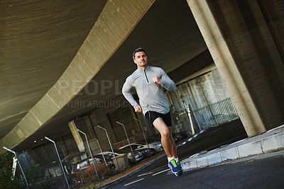 Buy stock photo Man, runner and exercise on road in outdoor, cardio and fitness or training for marathon. Male person, athlete and workout by city background, sportswear and performance challenge by bridge on street