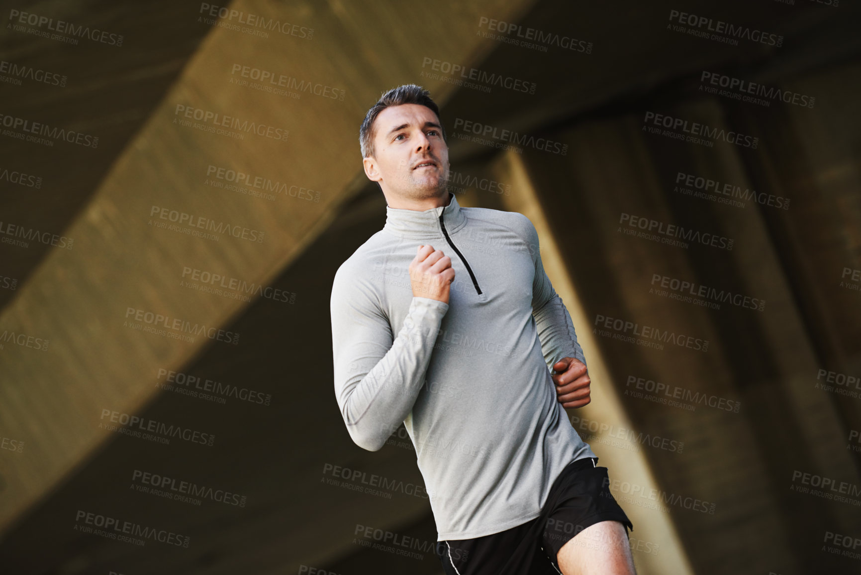 Buy stock photo Man, runner and wellness on street in outdoors, cardio and exercise or training for marathon. Male person, athlete and workout by city background, sportswear and performance challenge by bridge