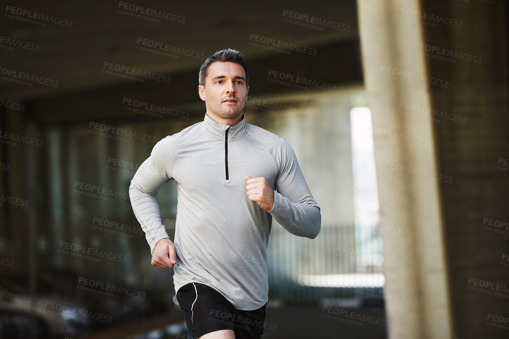 Buy stock photo Man, runner and training on street in outdoor, cardio and exercise or prepare for marathon. Male person, athlete and workout by city background, sportswear and performance challenge by bridge on road