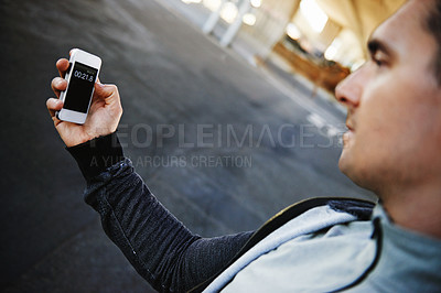 Buy stock photo Man, runner and checking phone in outdoors, screen and exercise or training for marathon. Male person, athlete and workout by city background, mobile app and performance challenge or timer on tech