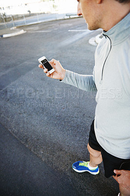 Buy stock photo Man, runner and checking phone for progress, screen and exercise or training for marathon. Male person, athlete and workout by city background, mobile app and performance challenge or timer on road