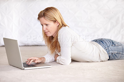 Buy stock photo Woman, work from home and laptop on floor, smiling and type email for job, copywriter or creative. Freelancer, technology and working for startup publishing company, internet and online worker

