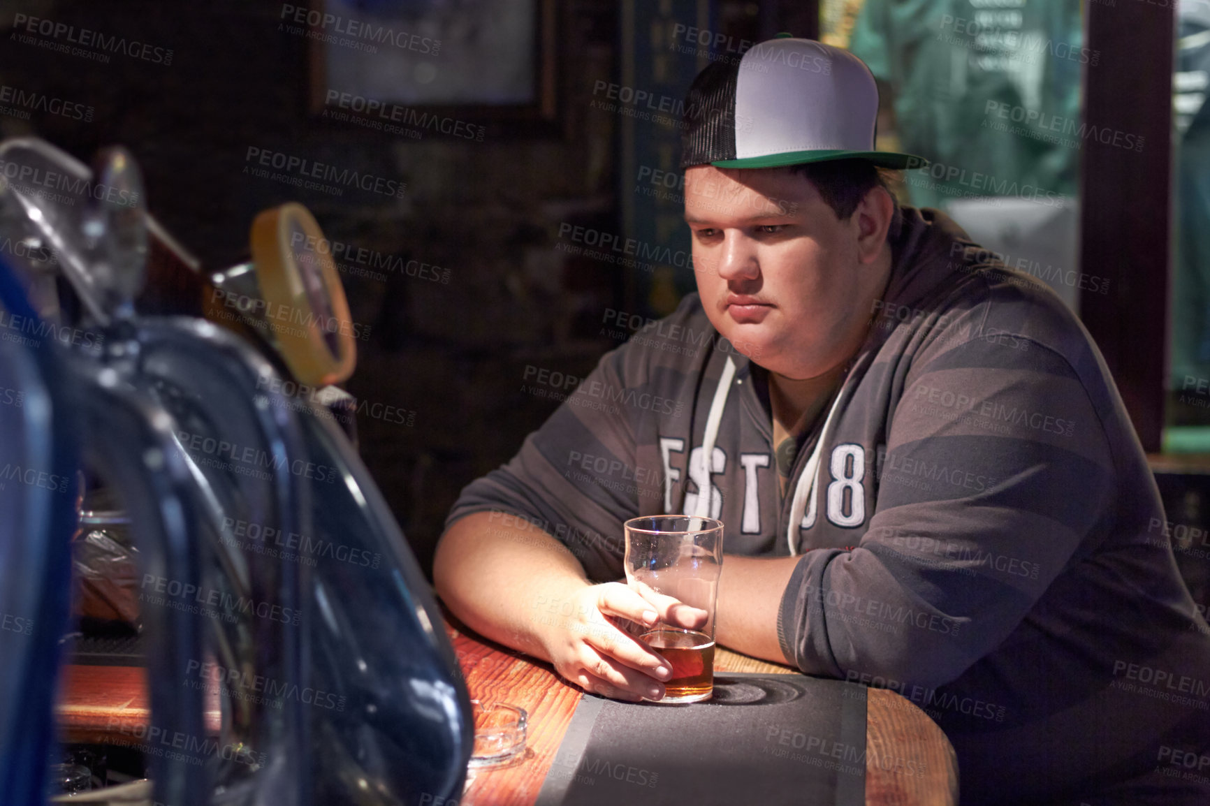 Buy stock photo Mental health problem, pub alcohol and sad man moody over emotional crisis, worry or mistake at restaurant, diner or club. Plus size, drinks and person depressed over fail, lonely or thinking of pain