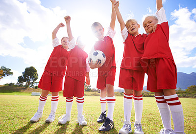 Buy stock photo Children, soccer team and celebration for winning or victory, happy and success in outdoors. People, kids and fist pump for achievement, collaboration and partnership or teamwork on field or sport