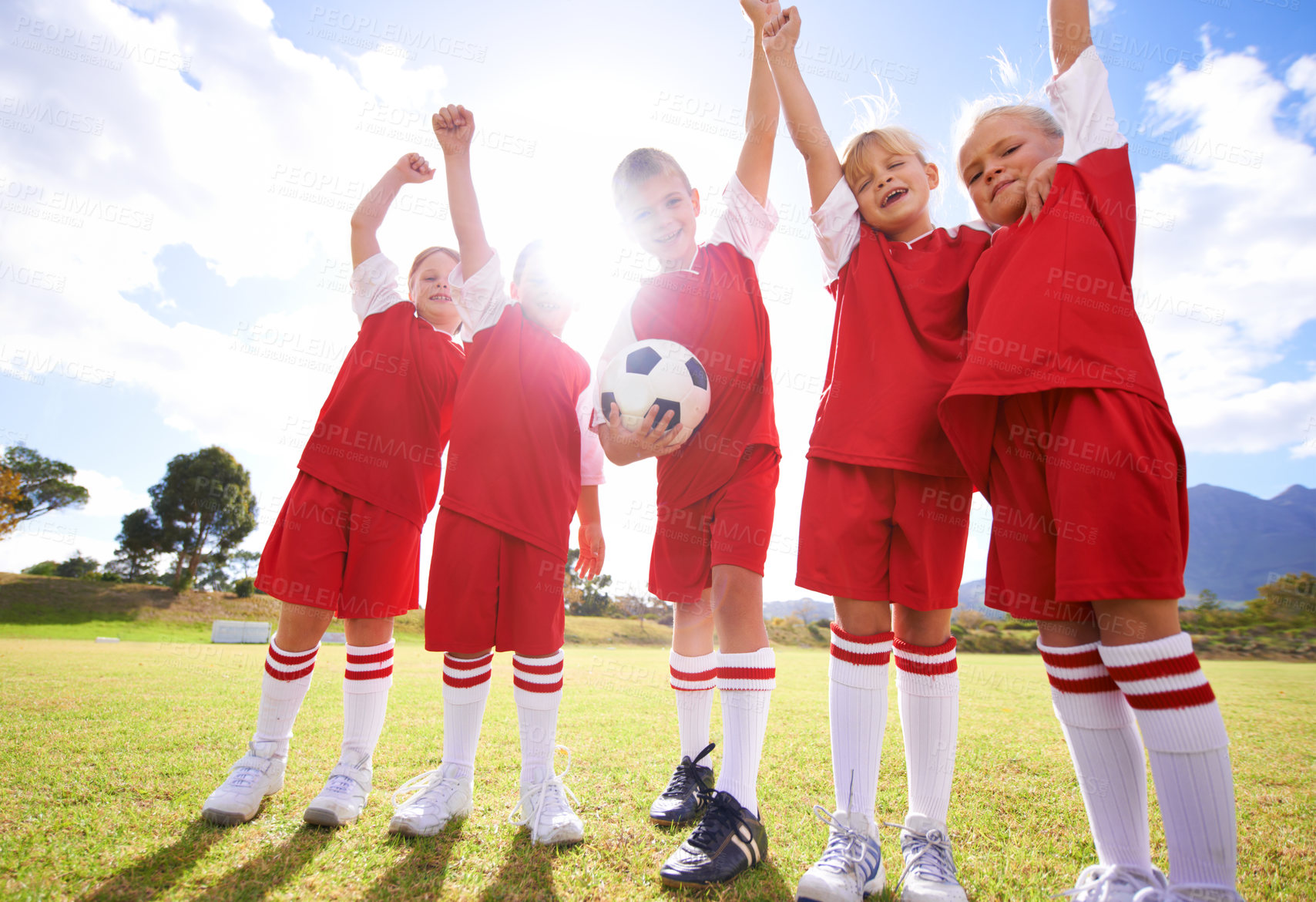 Buy stock photo Children, soccer team and celebration for winning or victory, happy and success in outdoors. People, kids and fist pump for achievement, collaboration and partnership or teamwork on field or sport