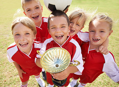 Buy stock photo Children, soccer team and portrait with cup, boys and girls with victory, support or solidarity. Achievement, sports and friendship, together and happy for win, ready for game or physical activity 
