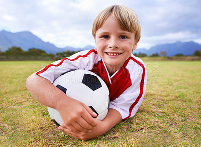 Buy stock photo Happy, soccer player and ball with portrait, exercise and ready for game, field and child. Outdoor, playful and sport for childhood, smile and athlete for match, alone and outside on football pitch