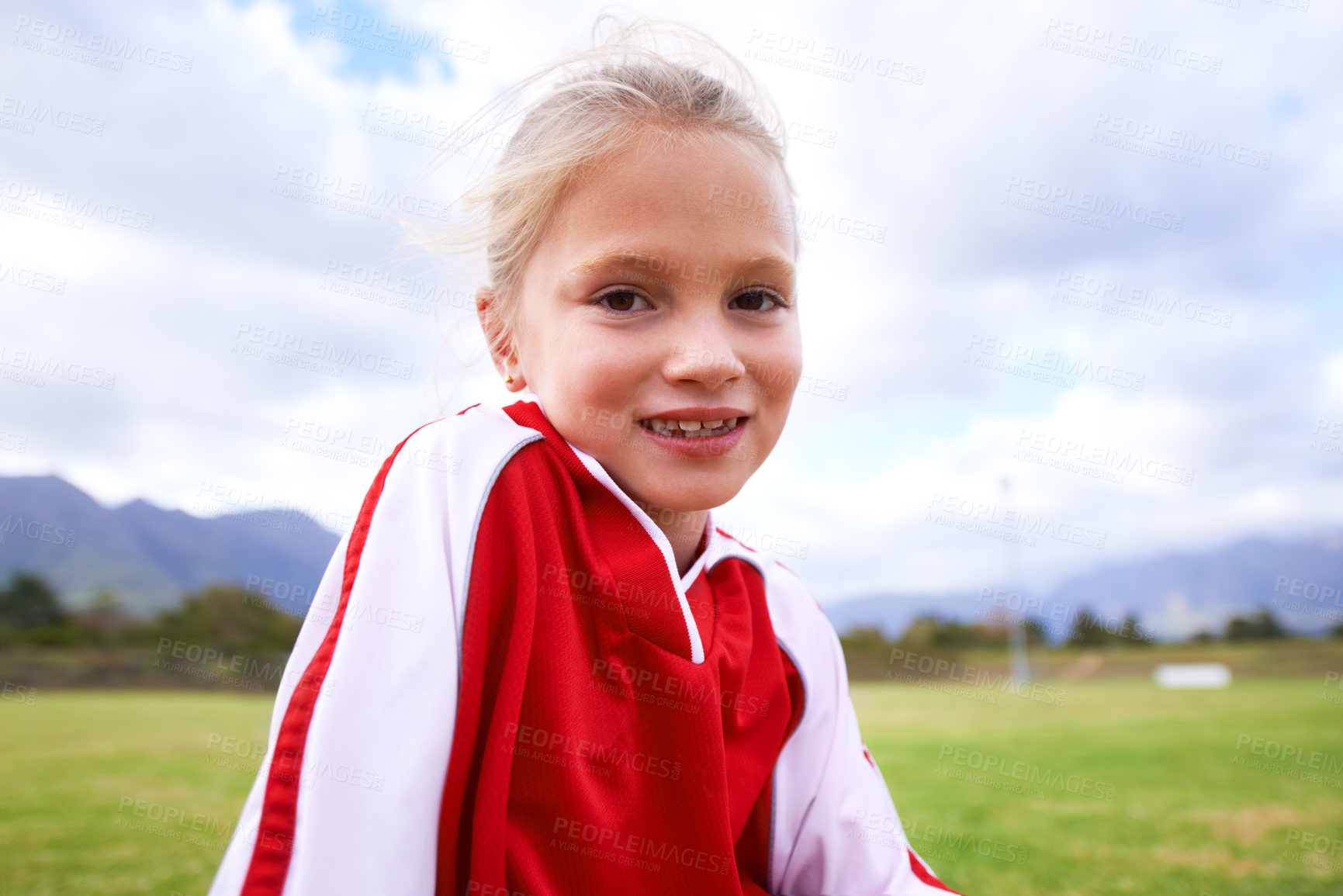 Buy stock photo Happy girl, portrait and soccer on green grass for sports, training or practice with clouds and blue sky. Face of female person or football player smile for game or match on outdoor field in nature