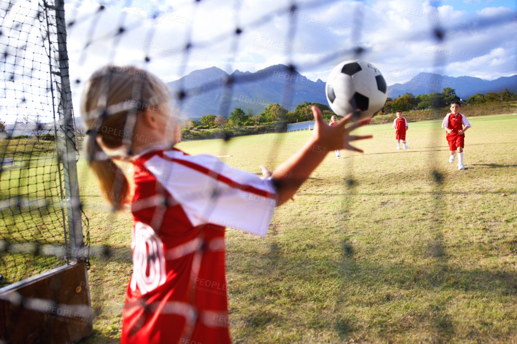 Buy stock photo Girl, soccer and ball with goal keeper for save, match or game from scoring point on outdoor field. Team of football players playing together for sports, competition or training practice in nature