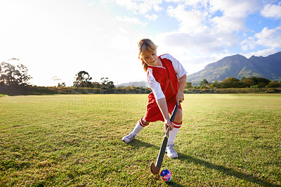 Buy stock photo Girl, green grass and playing hockey for sports, game or outdoor match in nature for practice. Female person, kid or playful child enjoying competition with ball on field for fitness or training