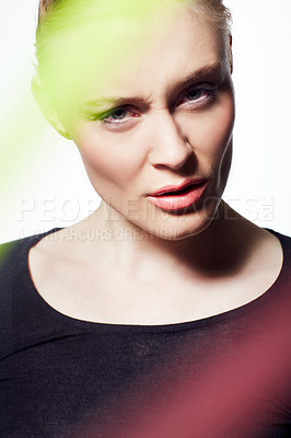 Buy stock photo Face, woman and beauty with light streak, confused or frown, creativity glow and skin on white background. Neon color, bright or shine with headshot, makeup and art deco, model with doubt in studio