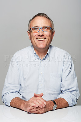 Buy stock photo Happy, smile and mature man in a studio with a good, confident and positive mindset with glasses. Happiness, spectacles and senior male person with excited face expression isolated by gray background