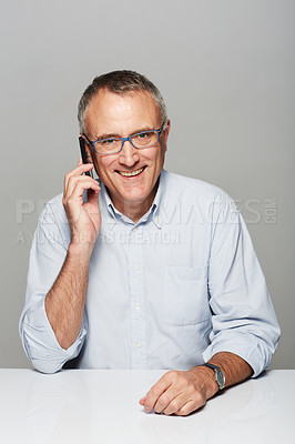 Buy stock photo Senior businessman, phone call and studio portrait with happiness, smile and listen by gray background. Elderly man, happy and excited face for contact, chat and smartphone for networking by backdrop