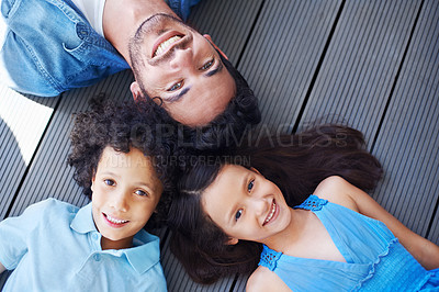 Buy stock photo Floor portrait, relax and happy kids, father or family bonding together, smile and happiness for youth growth. Love, face and top view of solidarity children, dad or group of people lying on ground