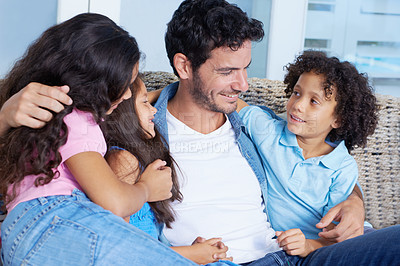 Buy stock photo Happy, hugging and father with children on sofa for bonding, love and care at family home. Smile, fun and young dad embracing and having fun with kids on couch of living room at modern house together