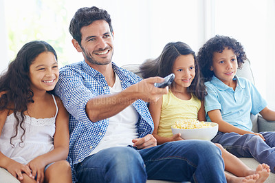 Buy stock photo Happy family, relax father and children watching tv, subscription comedy movie or streaming home entertainment. Bonding, remote control and house kids, dad or people with popcorn and television show