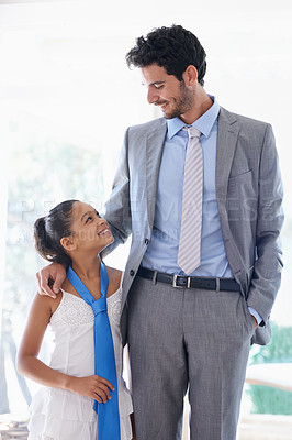 Buy stock photo Happy, tie and father bonding with child in living room of family home together for love. Smile, care and businessman or dad talking to girl kid with youth for conversation or communication at house.