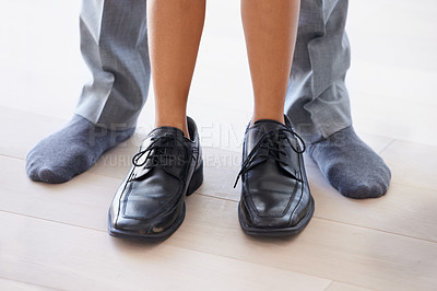 Buy stock photo Feet, man and child wearing shoes with dad, getting ready and morning with legs, closeup and socks. Standing, house and childhood for fun, young and bonding together with parent, home and playing