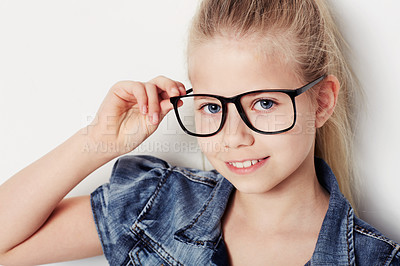Buy stock photo Portrait of a young girl wearing glasses posing in the studio