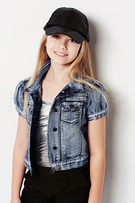 Buy stock photo Child, portrait and fashion in studio, cool and confidence by white background. Female person, girl and casual clothing or style by backdrop, kid and denim jacket pride or smiling for trendy cap