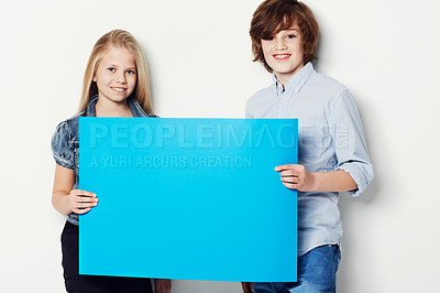 Buy stock photo Happy teens, portrait and billboard for advertising, marketing or mockup space on a white studio background. Young man and woman or gen z smile with blue poster or empty sign for presentation or vote