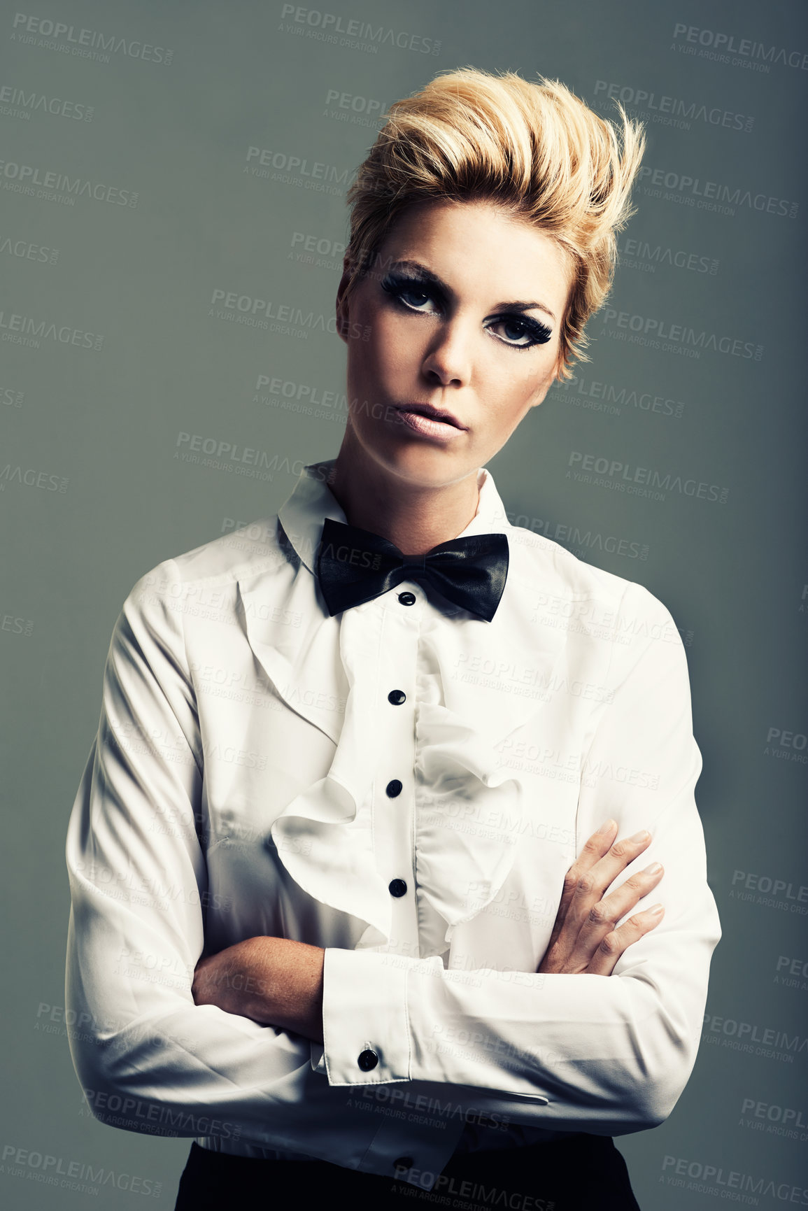 Buy stock photo Portrait, bow tie and woman with fashion, vintage clothes and classy aesthetic on grey background. Arms crossed, edgy fashionable model or cool girl with retro style and makeup isolated in studio
