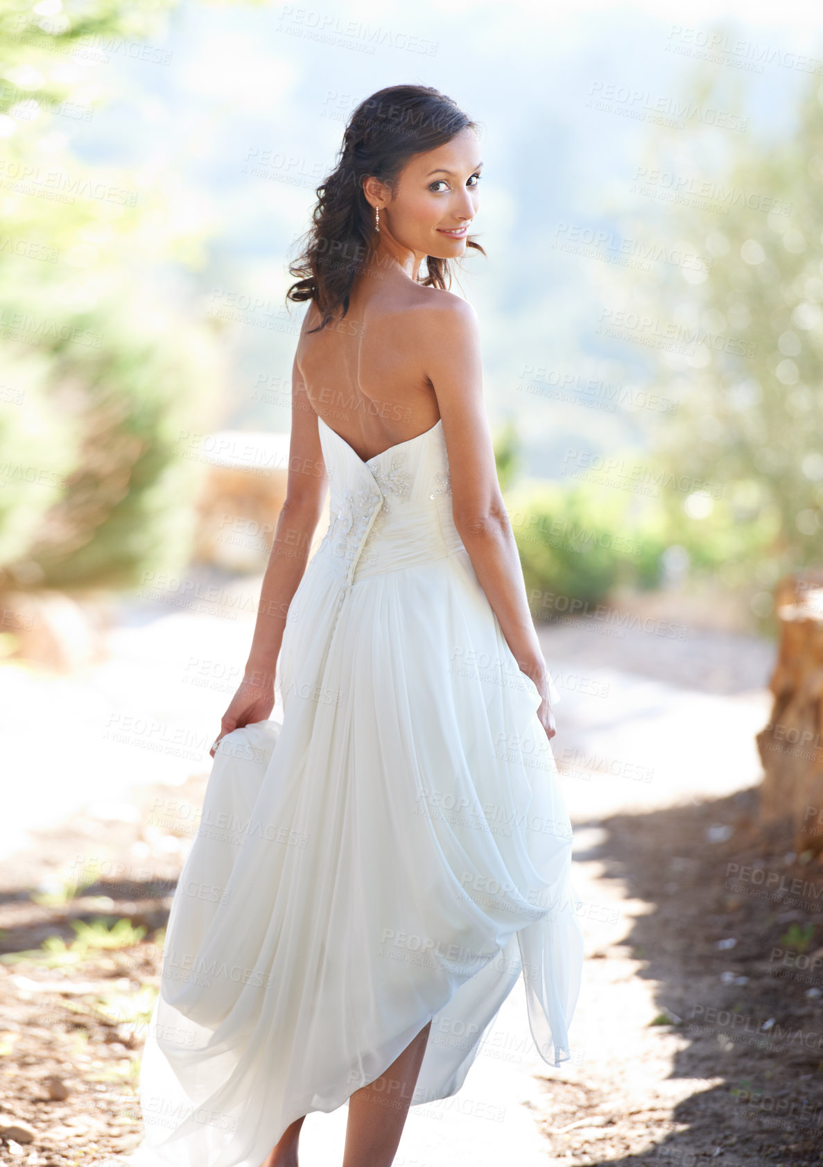 Buy stock photo Portrait of an attractive young woman in a wedding dress looking back