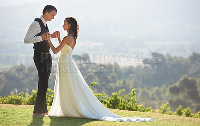 Buy stock photo Couple, bride and groom at wedding, outdoor in nature for social event, hand holding for love and commitment. Man, woman and marriage, celebrate with trust and care together on hill with life partner